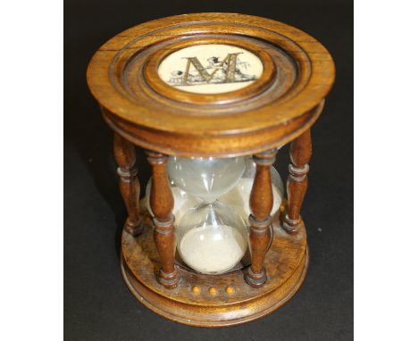 A 20th Century triple sand timer with ivorine disc to either end, marked "M", 12.5 cm diameter x 14 cm high 