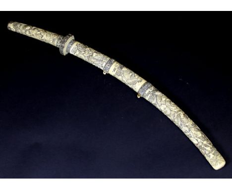 A 19th Century Japanese carved ivory cased katana, the handle and scabbard decorated with figural scenes, signed on medallion