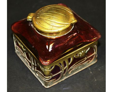 A circa 1900 Continental Art Nouveau iridescent ruby glass ink well with brass openwork Art Nouveau style lily decorated moun