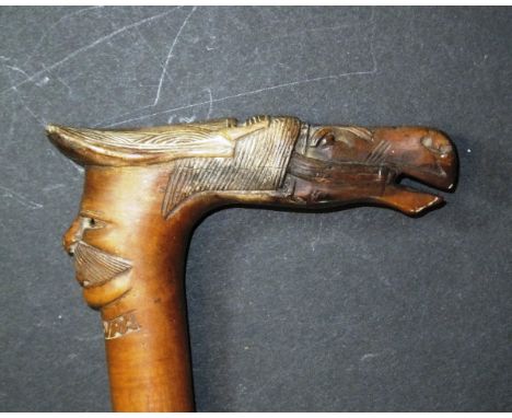 A carved wooden walking stick with horse head and moustached face inscribed "Kepkura", 88.5 cm long CONDITION REPORTS Overall