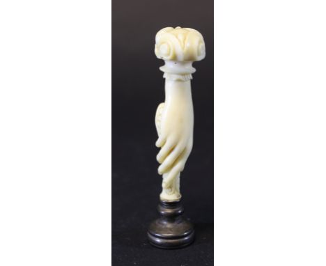 A Victorian carved ivory handled seal as a hand holding a seal with carved hardstone facia, 8.2 cm high CONDITION REPORTS Som