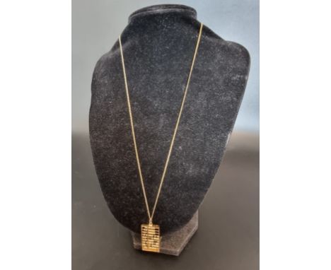 A yellow metal abacus pendant, stamped '14k', 32mm, on a gold plated chain. 