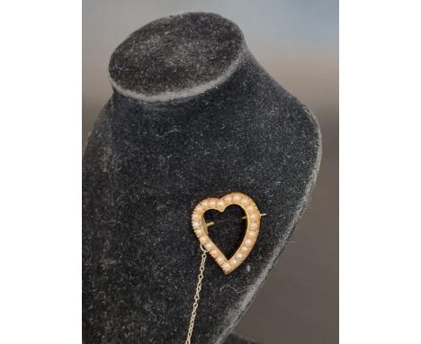 An Edwardian yellow metal pearl set open heart shaped brooch, 2.5cm high. 