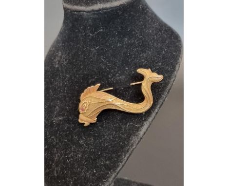 A stylised fish brooch, set ruby eye, stamped 750, 5.7cm. 