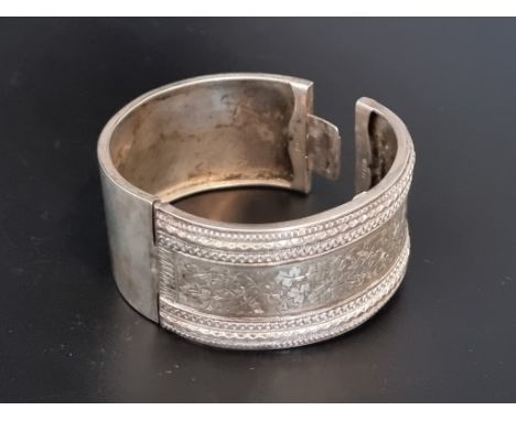 A hinged bangle, stamped 'Silver'. 