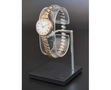 A vintage 9ct gold ladies wristwatch, on a later expanding plated bracelet. 