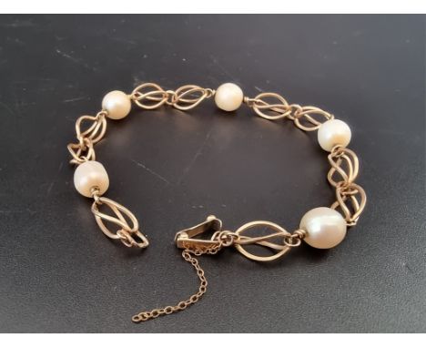 A vintage yellow metal fancy link bracelet, having five interspersed pearls, 20cm. 