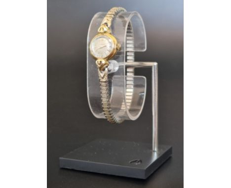 A vintage Omega manual wind ladies wristwatch, stamped 18k,&nbsp;Cal. 211, No. 12494582, on a later expanding bracelet. 
