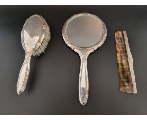 A German three piece dressing set; comprising hand mirror; hair brush and comb, all stamped 800. 