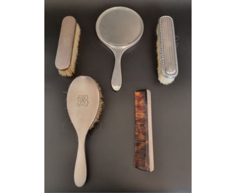 An engine turned silver three piece dressing set, London 1963/4; together with a similar comb and an unmatched hairbrush. (5)