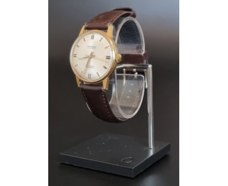 A vintage J W Benson gold plated manual wind wristwatch, 34mm, on leather strap. 