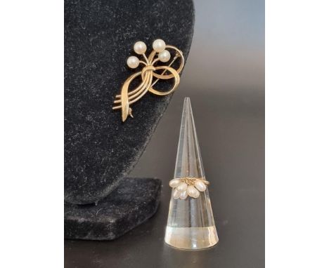 A floral spray bar brooch set four pearls, stamped 14k, 42mm; together with a ring, with seven attached pearls, stamped k18, 
