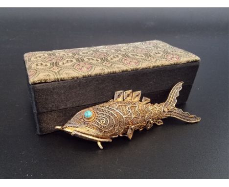 A Chinese articulated silver gilt and fish pendant, having turquoise set eyes, 7cm, boxed. 