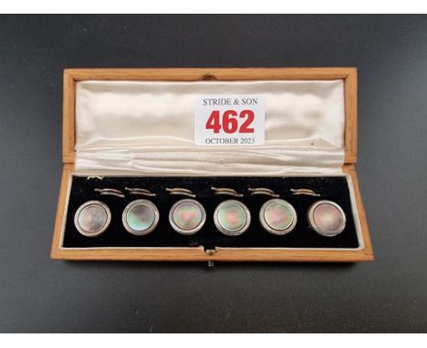 An oak cased set of six silver and mother of pearl buttons,&nbsp;by&nbsp;J Aitkin &amp; Son, 14mm diameter. 