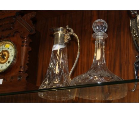 A SILVER PLATED CLARET JUG + A CUT GLASS SHIPS DECANTER  (2)