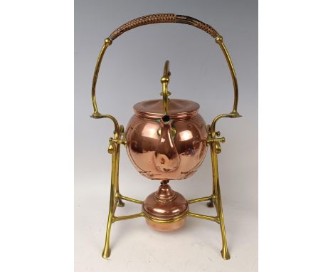 An Arts and Crafts style copper kettle on a stand, 35 cm