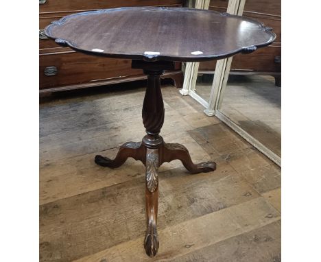 A George III style mahogany tilt top tripod table, the base with a birdcage support, 80 cm diameter