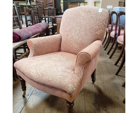 A 19th century style armchair, on mahogany legs to brass castors