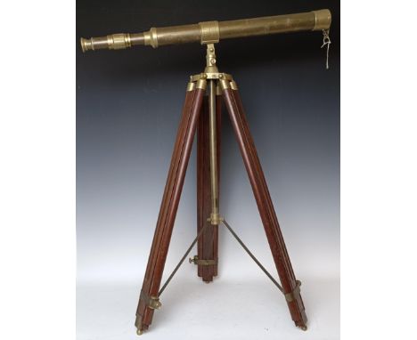 A brass telescope, with a stand, a brass candelabrum, and three swords