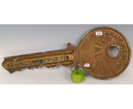 A large Yale metal advertising shop sign, in the form of a key, 77cm wide