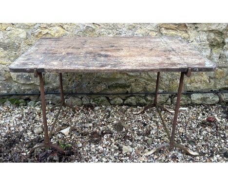 A pair of metal trestle table stands, with a wooden top, 122 cm wideWeathered and well used, sold as seen, various marks, los