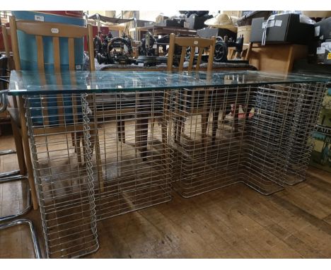 A Habitat chrome metal and glass deskGlass top 60 x 150 cm  wire racks 40 x 68 cm each Some light wear through the lot, due t