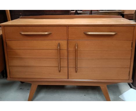 An Ernest Gomme teak sideboard, with two drawers and two cupboard doors, a matching dining table and four chairsSome splits a