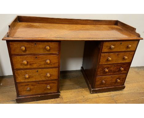 A 19th century mahogany kneehole desk, with a raised back, on two pedestals with four drawers each, 137 cm wide