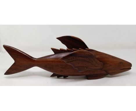 A carved wood Pitcairn Islands type fish, John Christian, 40 cm wide Some small knocks, losses and surface wear. Stand is not