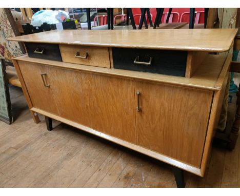 A 1970s dining room suite, comprising a sideboard, with three drawers and two cupboard doors, 152 cm wide, an extending dinin