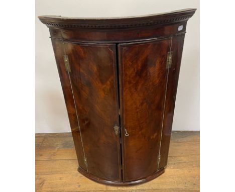 A 19th century mahogany bow front corner cabinet, 72 cm wide, and a mahogany bow front washstand, a&nbsp;George III style nes