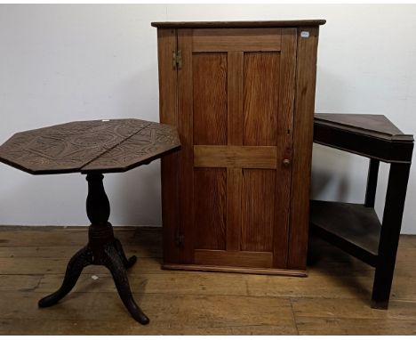 A Liberty's style carved octagonal table, 70 cm wide, and a corner cabinet on stand (2)