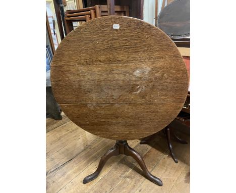 An oak tilt top table, 82 cm diameter, two occasional tables, a cheval mirror, three bedroom mirrors, two oval mirrors, an ar