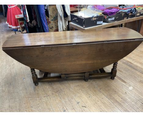 An oak drop leaf dining or wake table, 210 cm wide