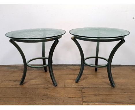 A pair of glass top side tables, on metal bases, 60 cm diameter (2)