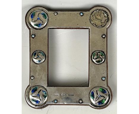 An Archibald Knox Cymric silver and blue green enamel photograph frame, Liberty & Co, Birmingham 1905, 13 x 11 cm Provenance: