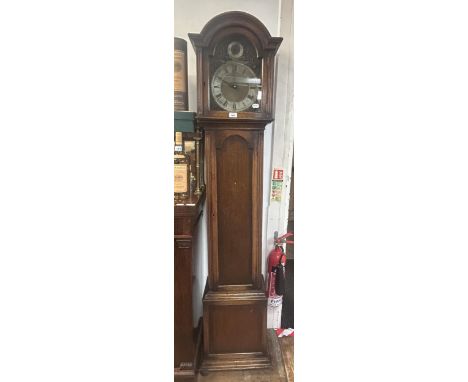 A longcase clock, the arched brass dial having a silvered chapter ring with St Michael, Whittington, and Westminster chimes t