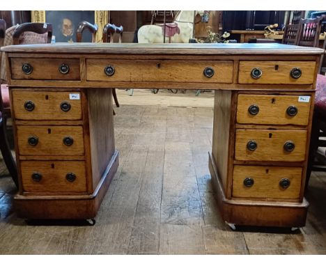 An oak pedestal desk, having a nine drawer configuration, 120 cm wide58.5 cm deep x 73 cm highlater/modern leather replacemen