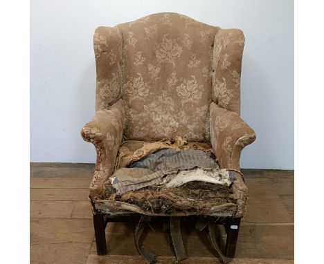 A 19th century wing armchair, in need of restoration