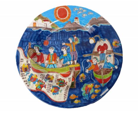 A large Italian Giovanni DeSimone maiolica pottery charger, decorated fishermen in a boat near a lighthouse, 50 cm diameterlo