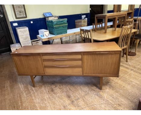 A teak sideboard, having three central drawers, flanked by two cupboard doors, 174 cm wideGeneral wear and tear, some light m