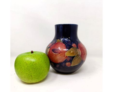 A Moorcroft pottery vase, decorated pomegranates, 14 cm higha few glaze faults, no visible chips, cracks or retoration