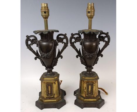 A pair of bronze and gilt bronze lamp bases, in the form of urns, 42 cm high (2)