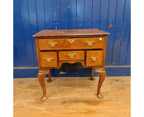 A walnut lowboy, having five drawers, on cabriole legs, 70 cm wide