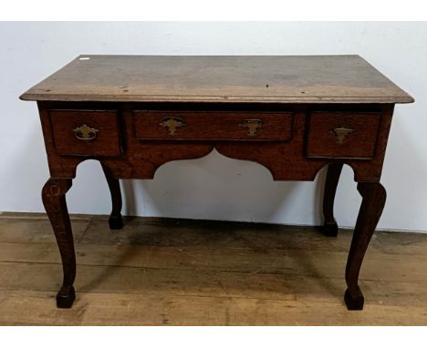 An oak lowboy, having three drawers, 100 cm wide