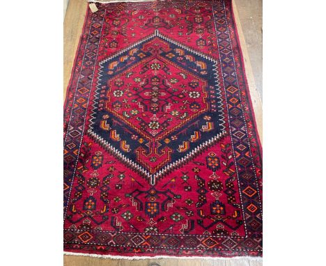 A Persian type red ground rug, 210 cm x 147 cm