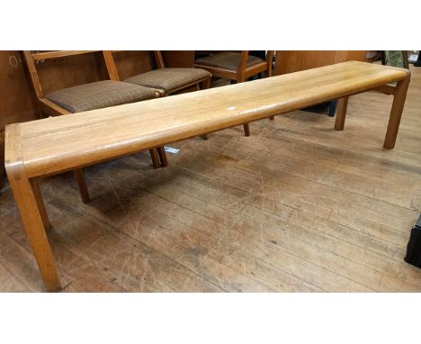 A 20th century light oak bench, 183 cm wide