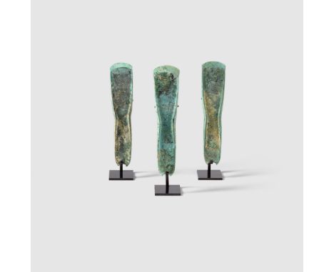 THREE BRONZE AGE AXES EUROPE, MIDDLE BRONZE AGE, C. 1400 B.C. cast copper alloy, all with curved blades and short vertical fl