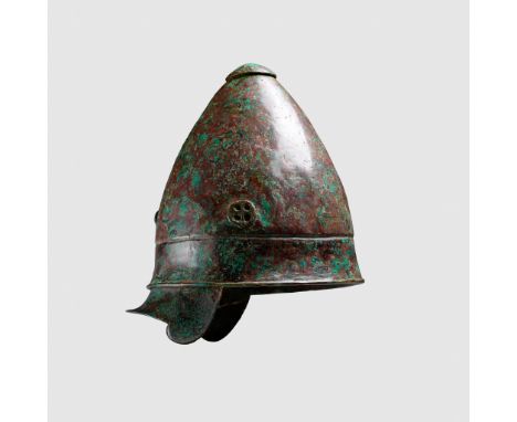 PILOS HELMET SOUTHERN ITALY, LATE 4TH - 3RD CENTURY B.C. hammered sheet bronze, of conical form, with a broad rim offset by r