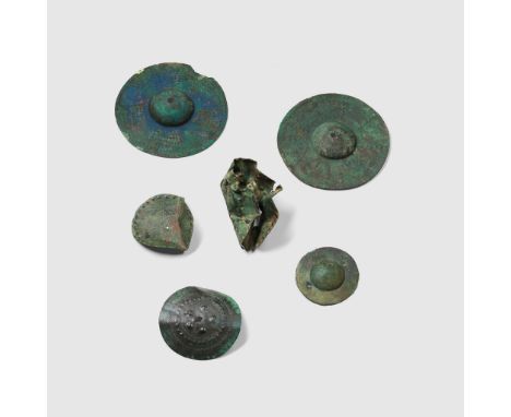 COLLECTION OF ANCIENT NEAR EASTERN SHIELD BOSSES AND FITTINGS NEAR EAST, 1ST MILLENIUM B.C. hammered bronze, all of circular 